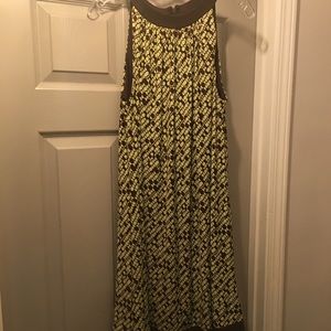 Cute little dress has a zipper in the back. Flairs out.